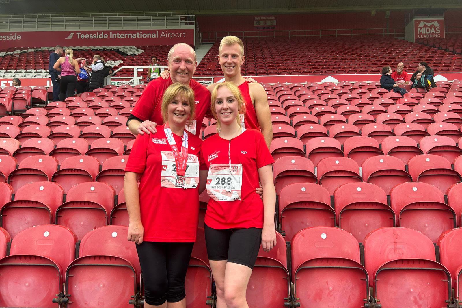 Bororunners members together at a race in the stadium